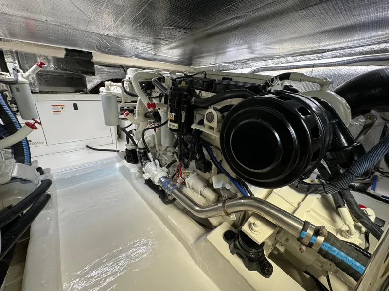 Slide: The Image of Engine room of 2003 Riviera 48 yacht, showcasing mechanical components and systems. - 31