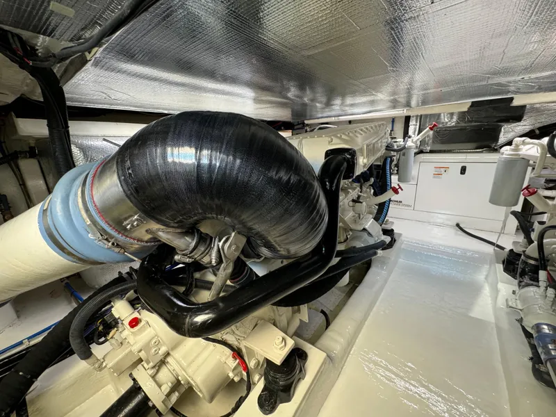 Slide: The Image of Engine room of 2003 Riviera 48 yacht, showcasing mechanical components and insulation. - 32