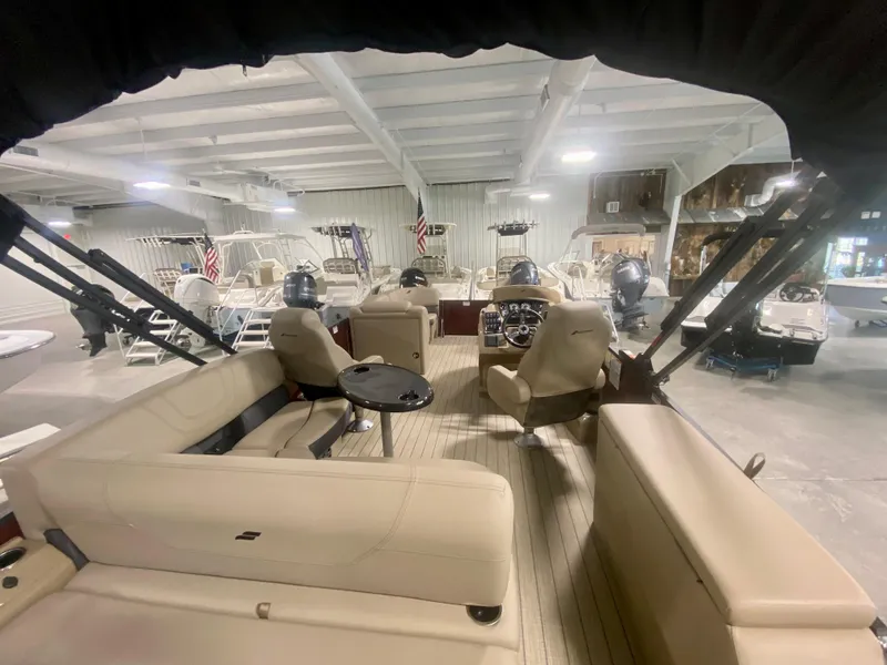 Slide: The Image of Interior view of 2024 Starcraft SLS 3 Q DH pontoon boat in showroom. - 10