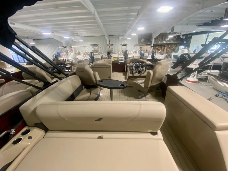 Slide: The Image of 2024 Starcraft SLS 3 Q DH pontoon boat interior with beige seating in showroom. - 31