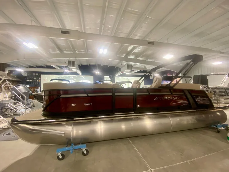 Slide: The Image of 2024 Starcraft SLS 3 Q DH pontoon boat in showroom. - 3