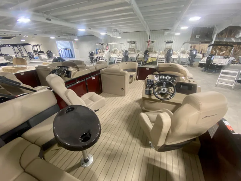 Slide: The Image of 2024 Starcraft SLS 3 Q DH pontoon boat interior with beige seating and modern dashboard. - 32