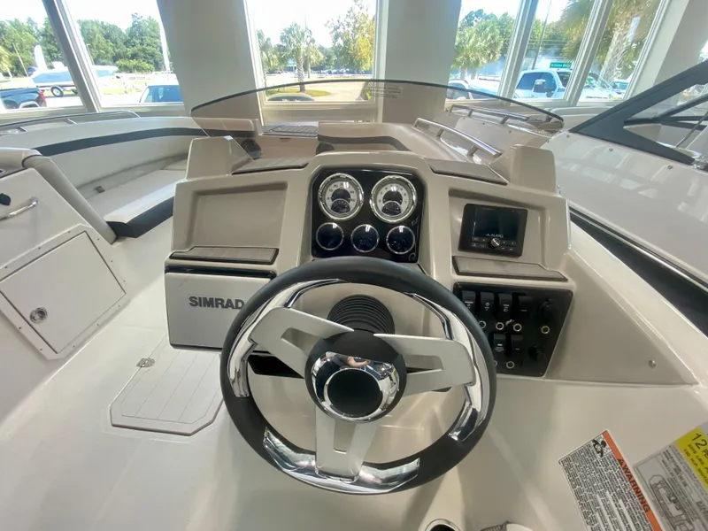 Slide: The Image of 2024 Starcraft SVX 191 boat dashboard with steering wheel and control panel. - 11