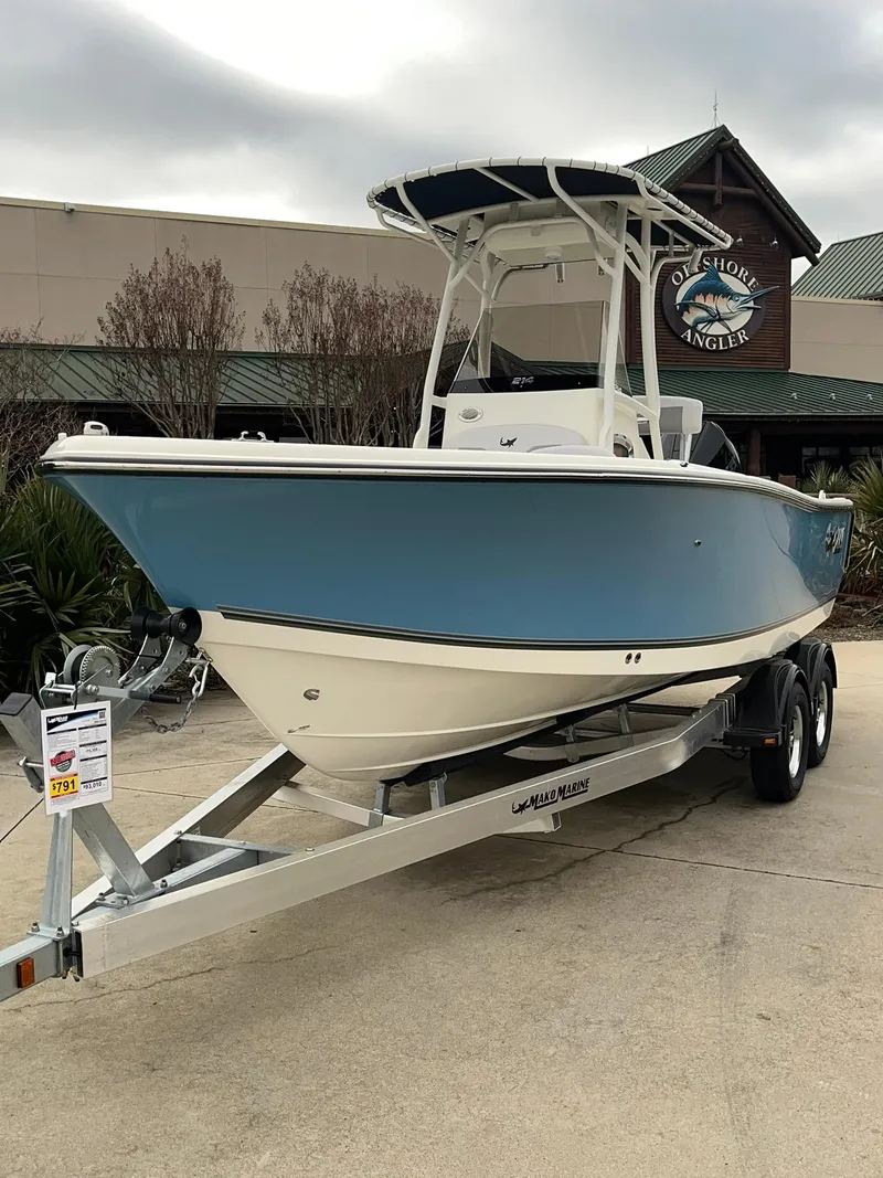 The Image of 2024 Mako 214 CC center console boat on a trailer outside a dealership. - 0