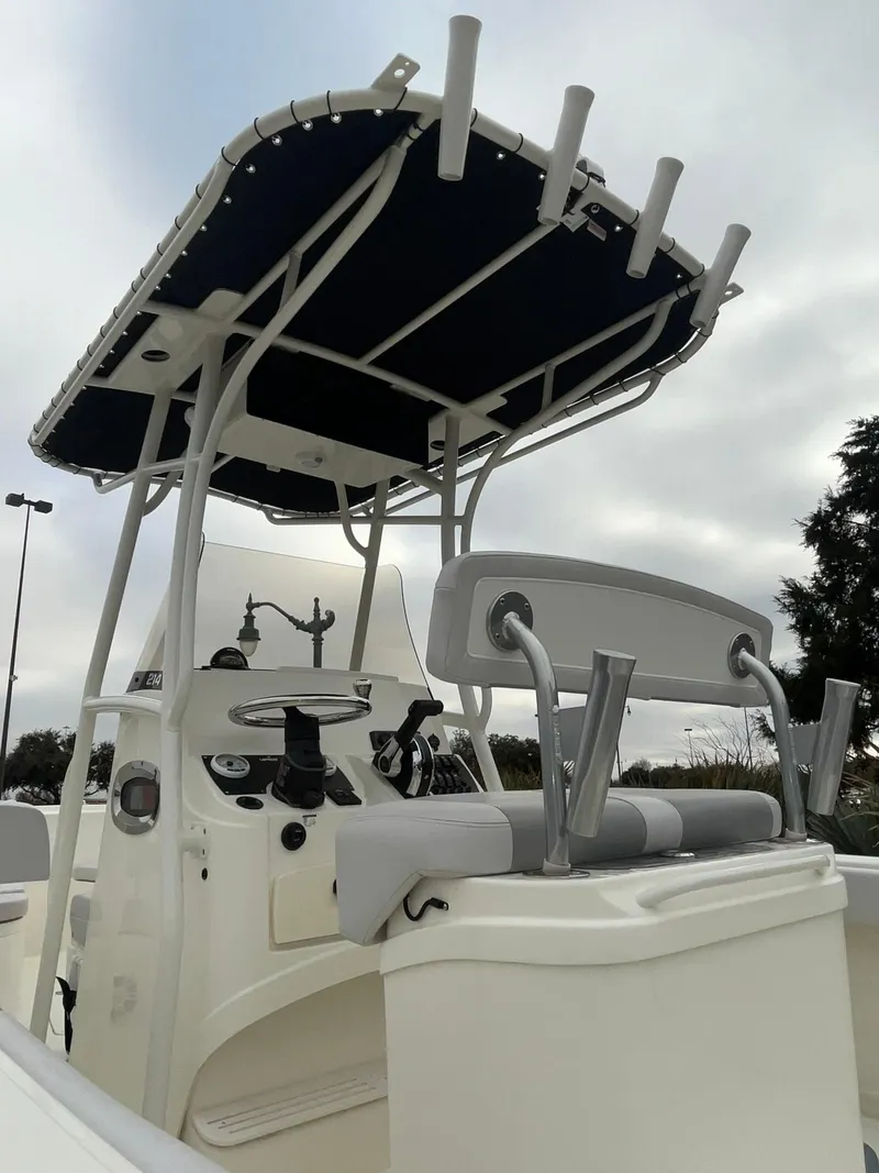 Slide: The Image of 2024 Mako 214 CC center console boat with T-top and seating. - 6