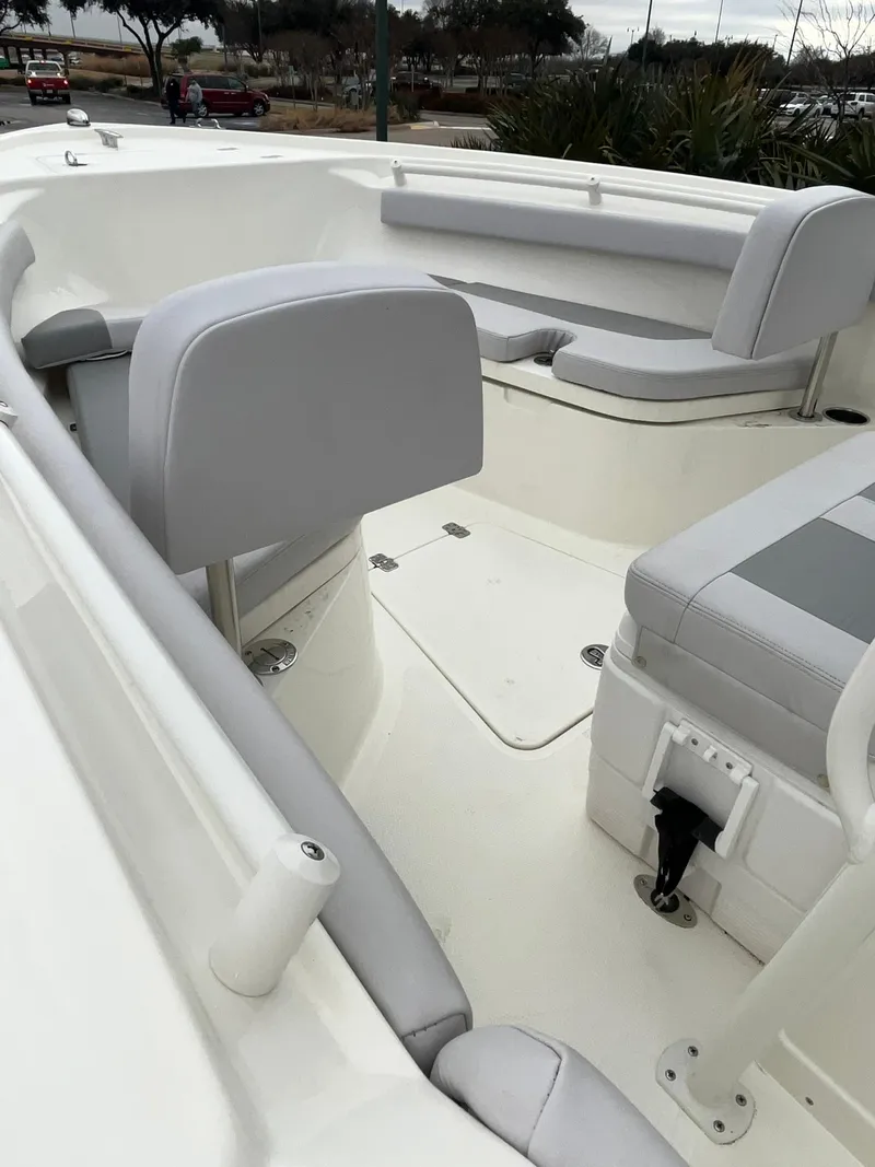 Slide: The Image of 2024 Mako 214 CC boat interior with gray seating and white deck. - 9