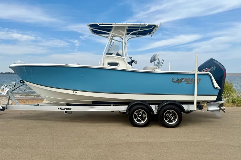 The Image of 2024 Mako 214 Center Console boat on trailer by the water. - 0