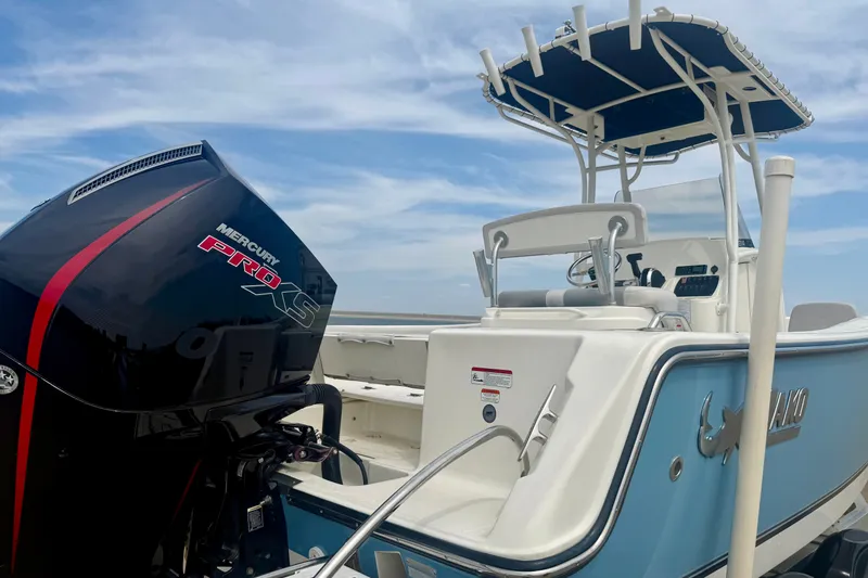 Slide: The Image of 2024 Mako 214 Center Console boat with Mercury Pro XS engine under blue sky. - 5