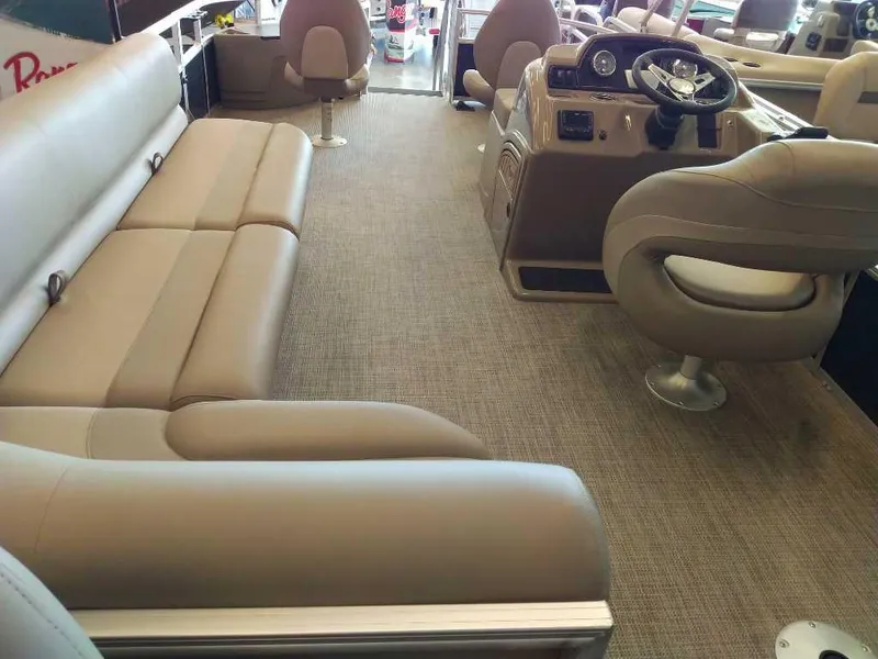 Slide: The Image of 2024 Ranger Reata 200F interior with beige seating and modern dashboard. - 1