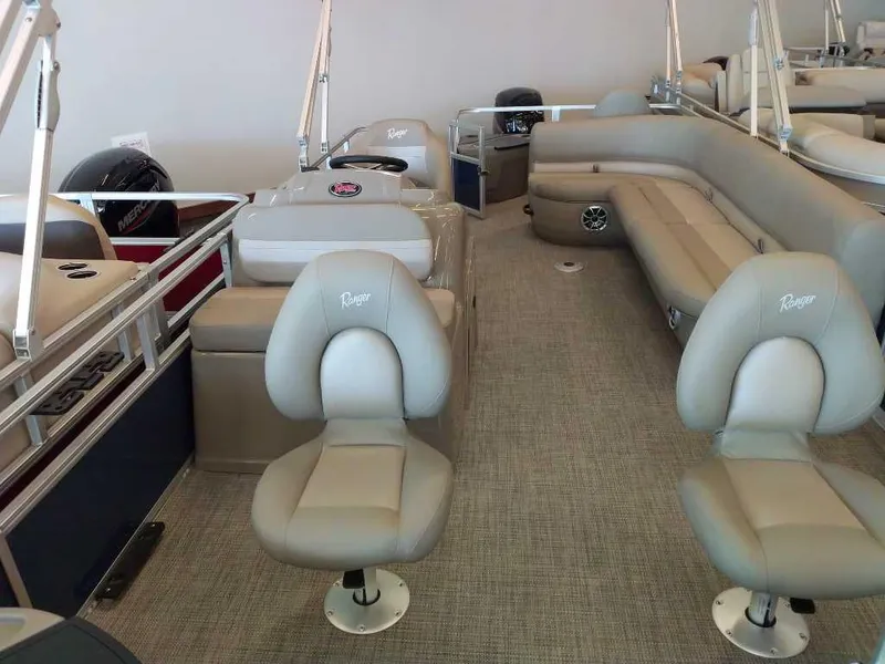 Slide: The Image of 2024 Ranger Reata 200F boat interior with beige seating and modern design. - 5
