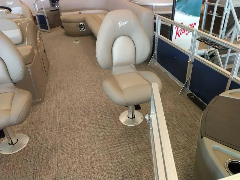 Slide: The Image of 2024 Ranger Reata 200F boat interior with beige seating and carpet. - 8