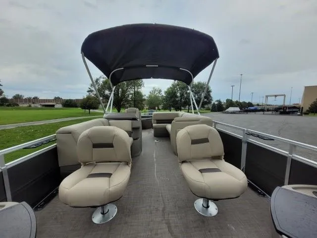 Slide: The Image of 2024 Sun Tracker Fishin' Barge 20 DLX pontoon boat with beige seating and canopy. - 3