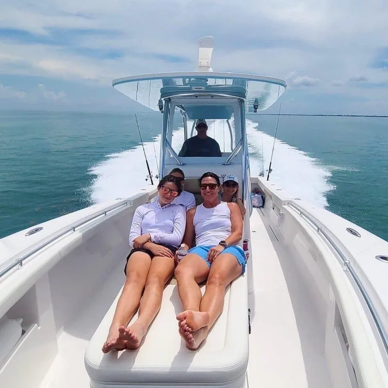 Slide: The Image of People relaxing on a 2025 Front Runner 33 CC Custom boat cruising on the ocean. - 14