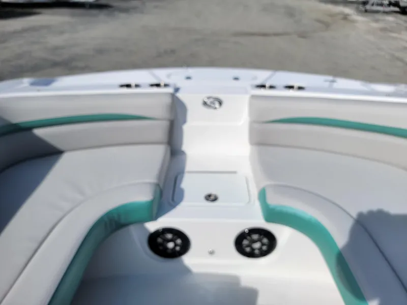 Slide: The Image of 2024 Hurricane SunDeck Sport 192 RL OB boat interior with cushioned seating and speakers. - 12