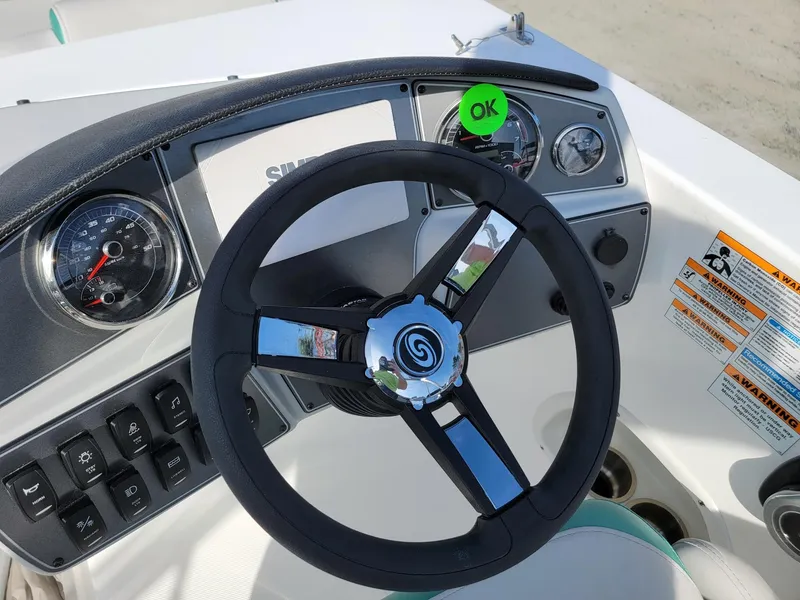 Slide: The Image of 2024 Hurricane SunDeck Sport 192 RL OB boat steering wheel and dashboard controls. - 16
