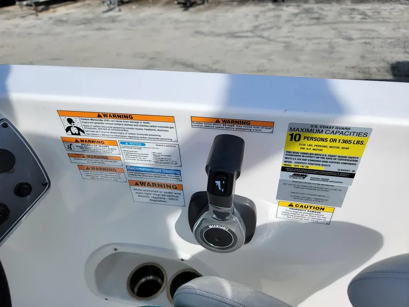 Slide: The Image of Control panel of 2024 Hurricane SunDeck Sport 192 RL OB with warning labels and capacity information. - 17