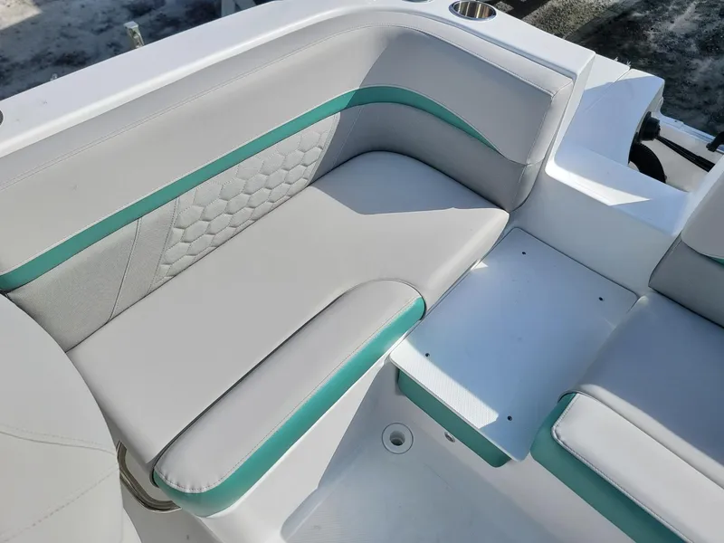 Slide: The Image of 2024 Hurricane SunDeck Sport 192 RL OB boat seating with teal accents. - 19