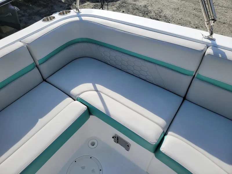 Slide: The Image of 2024 Hurricane SunDeck Sport 192 RL OB boat seating area with white and teal upholstery. - 21