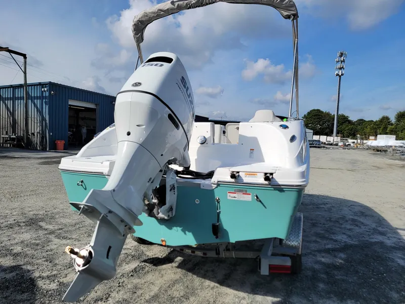 Slide: The Image of 2024 Hurricane SunDeck Sport 192 RL OB boat with outboard motor on trailer. - 4