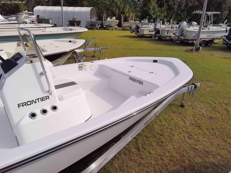 Slide: The Image of 2024 Frontier 180 boat on trailer, displayed outdoors in a boatyard. - 3