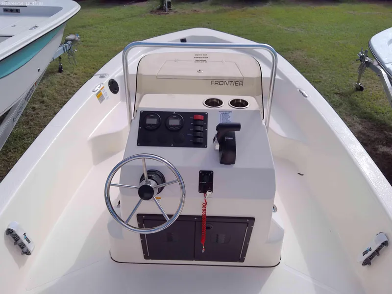 Slide: The Image of 2024 Frontier 18 boat console with steering wheel and controls. - 4