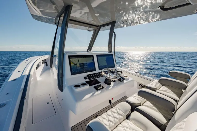 Slide: The Image of 2025 Front Runner 36 CC Custom boat interior with ocean view, featuring modern helm and seating. - 2