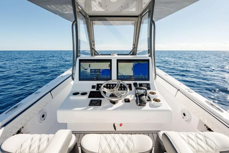 Slide: The Image of 2025 Front Runner 36 CC Custom boat dashboard with dual screens on open sea. - 3