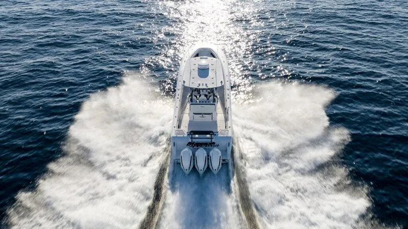 Slide: The Image of 2025 Front Runner 36 CC Custom boat speeding on open water, creating a dynamic wake. - 4