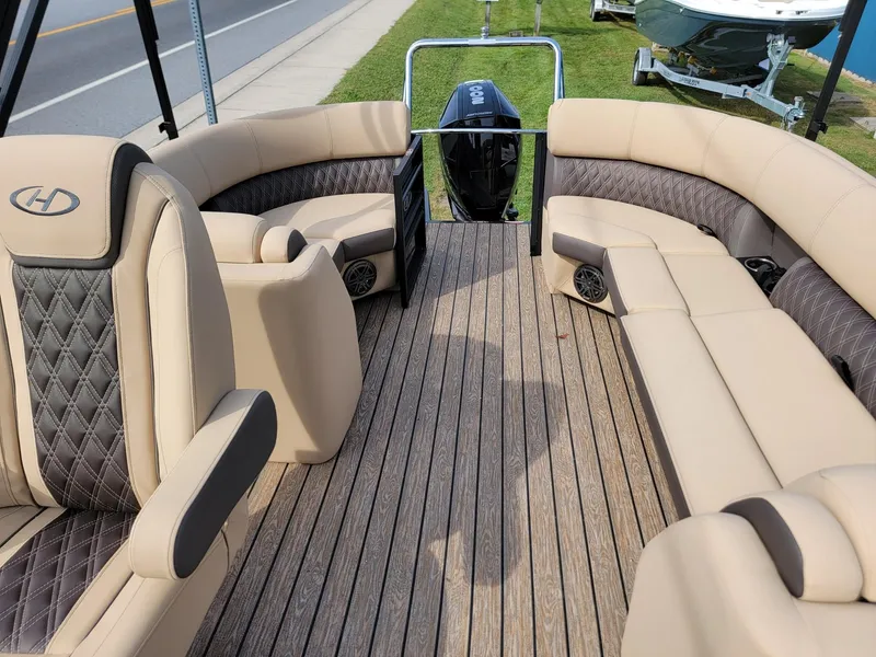 Slide: The Image of 2024 Harris Sunliner 210 boat interior with beige and black seating. - 12