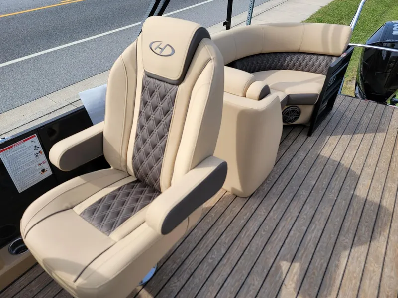 Slide: The Image of 2024 Harris Sunliner 210 boat interior with beige and gray seating. - 14