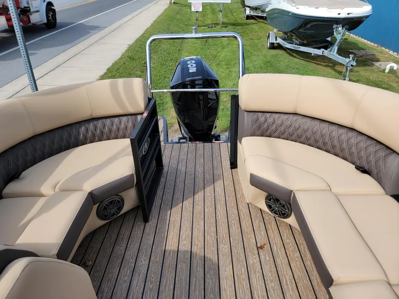 Slide: The Image of 2024 Harris Sunliner 210 boat interior with beige seating and wood flooring. - 20