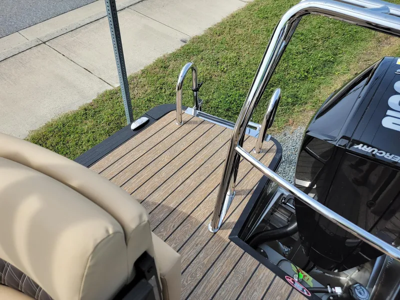 Slide: The Image of 2024 Harris Sunliner 210 boat with Mercury outboard motor and swim ladder. - 25