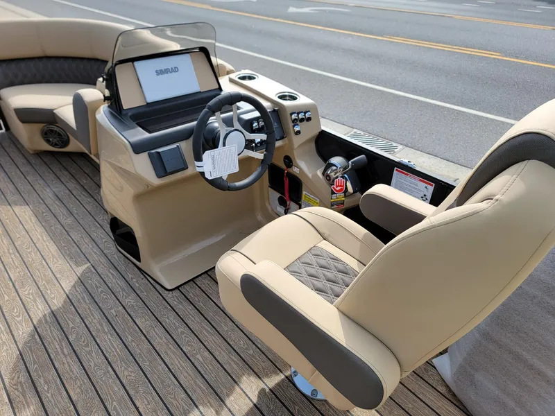 Slide: The Image of 2024 Harris Sunliner 210 boat interior with steering console and seating. - 29