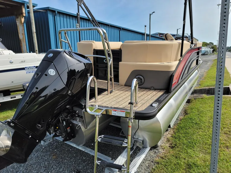 Slide: The Image of 2024 Harris Sunliner 210 pontoon boat with outboard motor and ladder. - 3