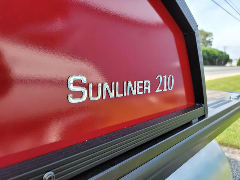 Slide: The Image of Close-up of 2024 Harris Sunliner 210 boat model nameplate. - 36
