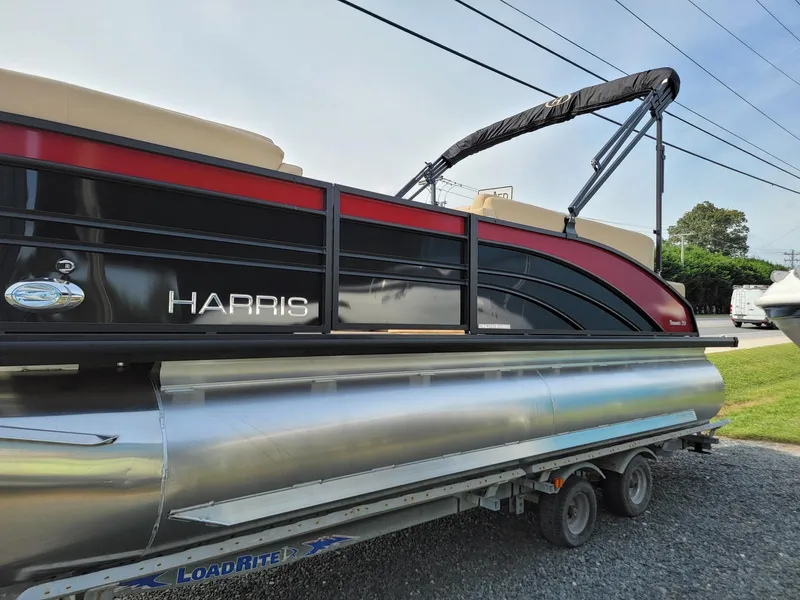 Slide: The Image of 2024 Harris Sunliner 210 pontoon boat on a trailer. - 6