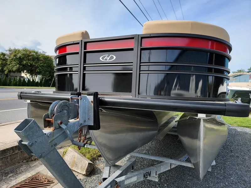 Slide: The Image of 2024 Harris Sunliner 210 pontoon boat on a trailer. - 8