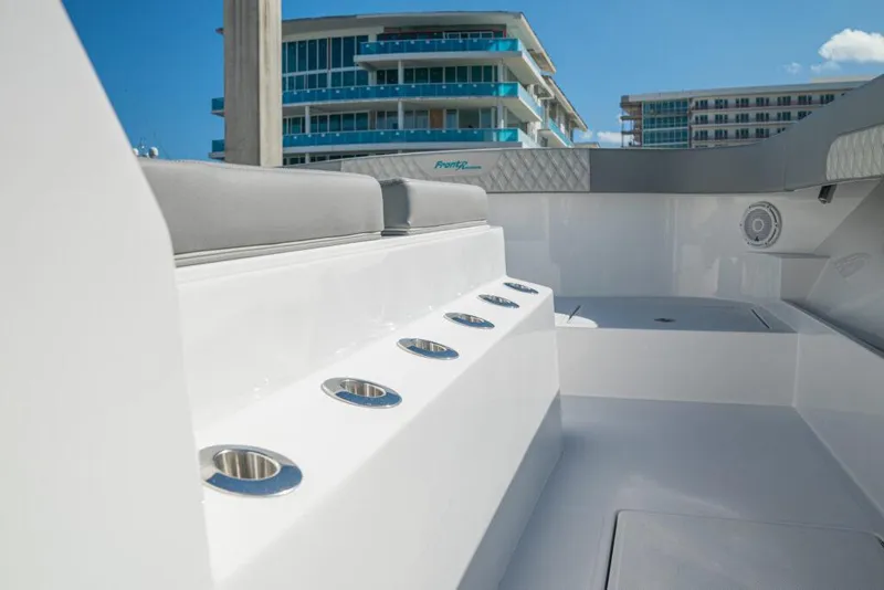 Slide: The Image of 2026 Front Runner 37 Catamaran interior with rod holders, modern design, and urban backdrop. - 16