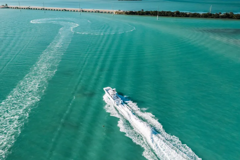 Slide: The Image of Aerial view of 2026 Front Runner 37 Catamaran cruising in turquoise waters. - 32