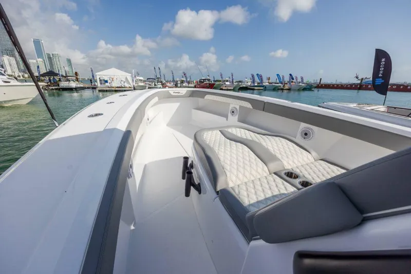 Slide: The Image of 2024 Front Runner 39 CC Custom boat at marina, featuring luxurious seating and modern design. - 17