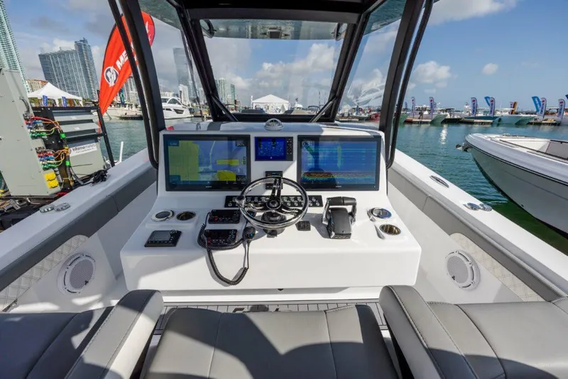 Slide: The Image of 2024 Front Runner 39 CC Custom boat helm with advanced navigation systems at marina. - 3
