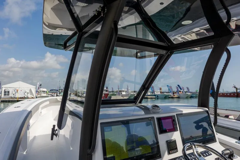 Slide: The Image of 2024 Front Runner 39 CC Custom boat dashboard and controls at marina. - 5