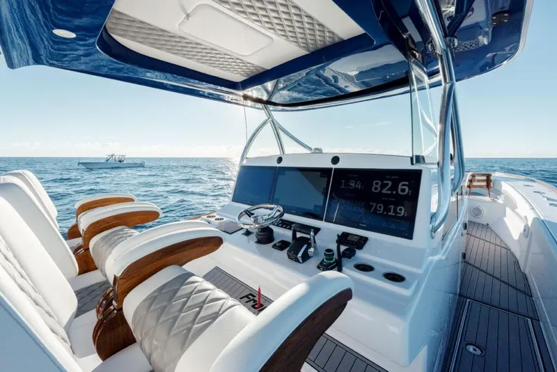 Slide: The Image of 2024 Front Runner 47 CC Custom boat interior with advanced navigation system and luxurious seating. - 2
