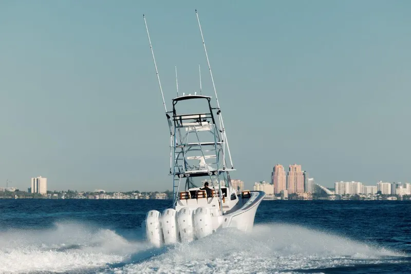 Slide: The Image of 2024 Front Runner 47 CC Custom boat cruising on water with city skyline in background. - 23
