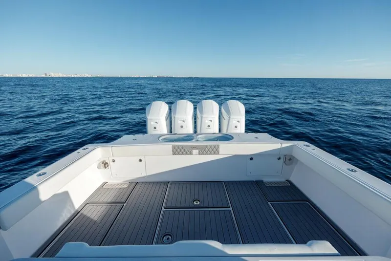 Slide: The Image of 2024 Front Runner 47 CC Custom boat with quad outboard engines on open sea. - 4