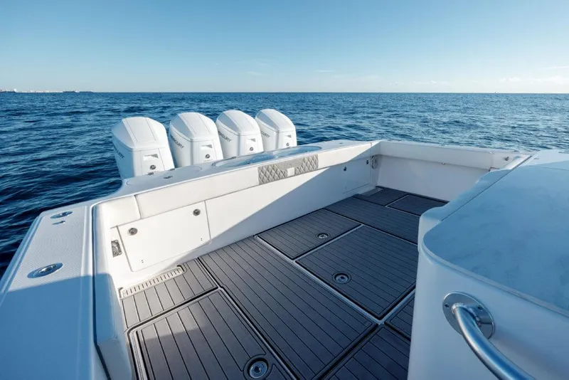 Slide: The Image of 2024 Front Runner 47 CC Custom boat deck with quad outboard engines. - 5