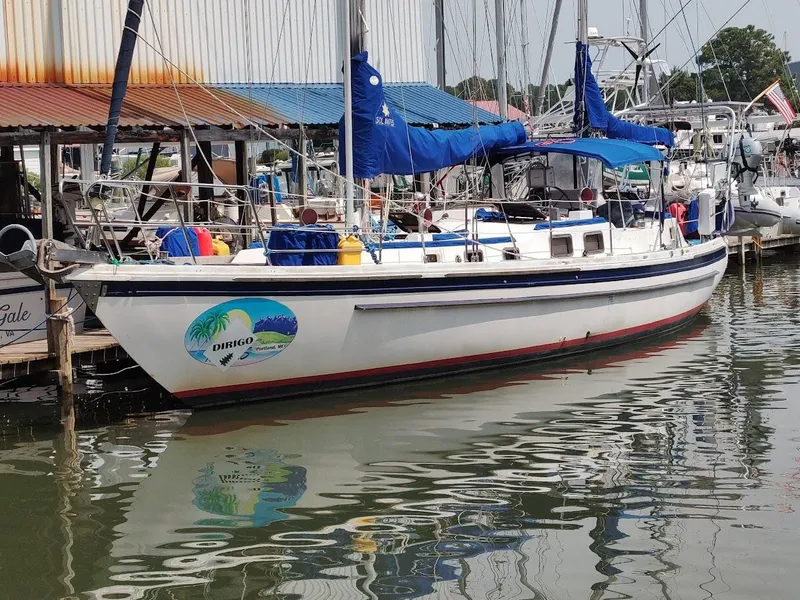 The Image of Sailboat Bruce Roberts 450, 1981 model, docked at marina with blue covers. - 0
