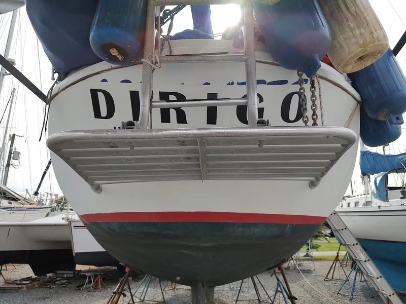 Slide: The Image of Bruce Roberts 450 sailboat from 1981, named "DIRIGO," docked with fenders visible. - 10