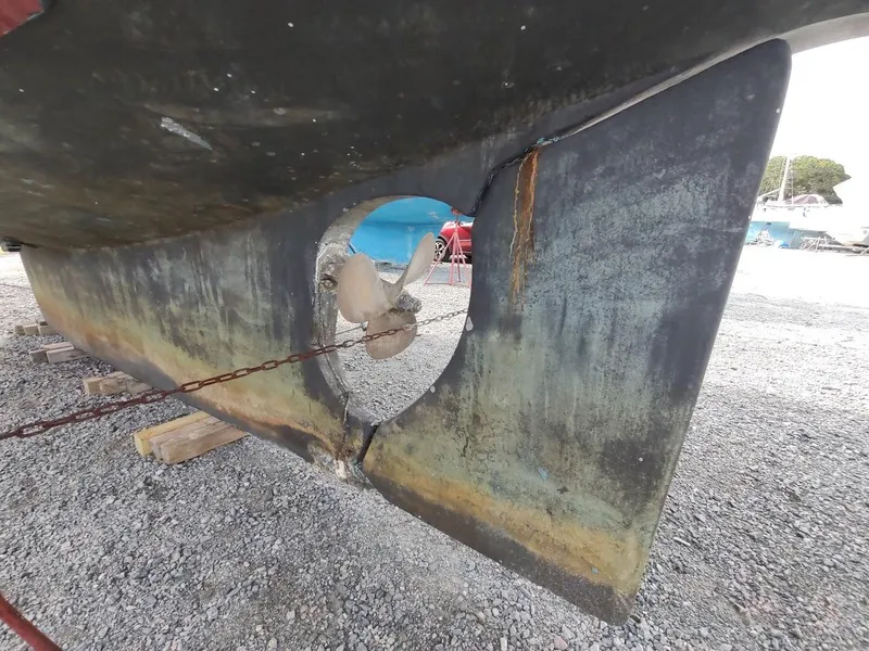 Slide: The Image of 1981 Bruce Roberts 450 boat propeller and rudder on dry dock. - 11