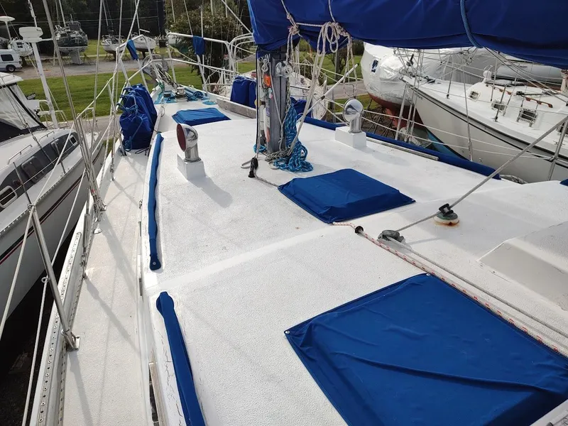 Slide: The Image of Sailboat deck of 1981 Bruce Roberts 450 with blue covers and rigging. - 16
